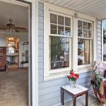 Charming details include a rocking chair front porch, high coved ceilings, original old-growth fir floors under carpet, and a cozy wood-burning stove with brick surround. 