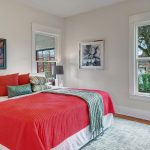 Two generous bedrooms share the floor with period details like walk-in closets. The east bedroom enjoys morning light from the east and a south-facing window into the side yard for plenty of light throughout the day.