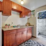 From the family room, you'll find this cheerful kitchenette, just waiting for your finishing touches to make it a full second kitchen with exterior access.