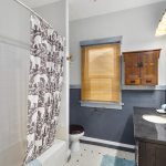 The updated full bath serves the home, adjacent to the main bedroom.