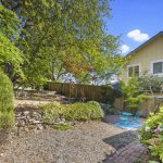 Escape to the serene, beautifully landscaped backyard and sunny brick patio.