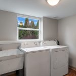 The day-lit laundry room faces the terraced back yard and has plenty of space for a 'real' washer and dryer, a full-size utility sink, and some storage. The electrical service panel is located in this room as well. Make it a stackable washer and dryer potentially even a 2nd kitchen!?