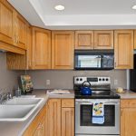 The spacious kitchen boasts newer solid oak cabinets that offer plenty of storage and a touch of rustic charm. 