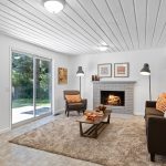 Entertain in the family room with a second cozy fireplace, powder room, and back yard access. There are two fireplaces on opposite sides of the home. 