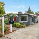 Discover this storybook starter home in Seward Park, a peaceful haven on a quiet dead-end street. 
