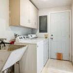 From the kitchen, you'll discover a spacious laundry room complete with a utility sink, cabinetry, and ample pantry space. This room makes household tasks a breeze and offers convenient access from the driveway, making it easy to bring in groceries and more.