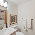 Just across the hall, a handy powder room is equipped with laundry amenities for ultimate convenience. The included washer and dryer set the stage for easy living, with an optional gas hookup ready for a future dryer upgrade.