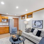 “Cozy Gatherings Meet Culinary Convenience” - The family media room, a versatile space for entertainment and relaxation, is complemented by a stylish kitchenette, perfect for quick snacks or elaborate intermissions. 