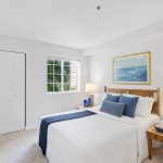 Serene views await in the spacious primary bedroom, complete with a walk-in closet for ample storage. Enjoy the convenience of direct access to the updated bathroom and laundry room just across the hallway, streamlining your daily routines.