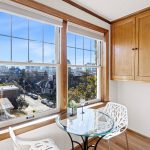 The kitchen’s cozy eating nook is framed by two large south-facing windows, filling the space with natural light and a connection to the outdoors, perfect for savoring your morning coffee in the sun.