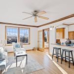 Perched on the top floor, this sun-drenched living room is your private retreat in the sky. Original leaded glass windows frame captivating cityscapes and golden sunsets, filling the space with warmth and timeless charm.