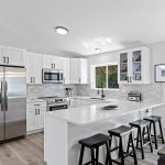 Fully remodeled kitchen with sleek quartz counters, stainless appliances, and custom cabinetry.