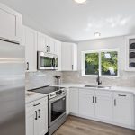 Brand-new stainless appliances, an undermount sink, and expansive counters elevate both form and function.