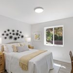 Serene bedroom with sunny yellow accents and stylish wall décor.