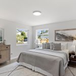 The primary suite is a serene retreat at day’s end—bathed in soft natural light from dual windows, with space for a king bed and more.