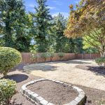 Mature trees frame the fully fenced yard for beauty and privacy.