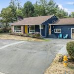 Fresh exterior paint, Goldfinch-yellow door, and side-entry seating add personality and welcome.