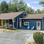 Convenient horseshoe driveway with easy in-and-out access, mature landscaping, and elevated curb presence.