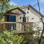 Built into the hillside beside Lewis Park, this North Beacon Hill home offers two private living areas and uncommon flexibility for multi-generational living.