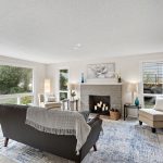 Oversized picture window anchors the room and brings in steady light from the front yard.