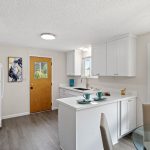 Beautifully reimagined kitchen with quartz countertops, soft-close cabinetry, and a peninsula for added storage and bar seating.