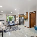 Tile floors and big windows give this lower-level living space a bright, grounded feel. East-facing exposure brings in peaceful morning light through the trees.