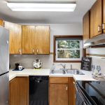 Framed by trees, the kitchen looks east for gentle morning light—ideal for a calm start to the day.
