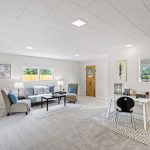 This lower flex room adds incredible versatility to the home—ideal for a second living area, media space, playroom, or creative studio. Thoughtfully set apart from the main living areas, it offers both quiet and connection. With fresh carpet underfoot, new lighting overhead, and access to the front driveway, this space adapts with ease.