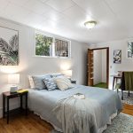The spacious lower-level suite includes a walk-in closet, real hardwood floors, and windows that welcome west-facing light—ideal for rest, work, or retreat.