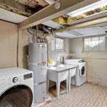 From the deck, step into a 370 sq ft partially finished laundry and utility room—complete with washer/dryer, deep utility sink, counter space for folding, and natural light. Quietly tucked away from the living areas, it keeps chores out of sight and sound.
