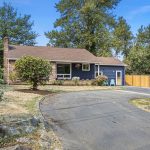 Horseshoe driveway offers ample off-street parking and frames the home’s inviting front elevation.
