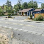 Before you even reach the porch, this home makes an impression: a hand-set stone address marker, goldfinch-yellow door, and bold navy trim—all set on a wide, 9,000-square-foot lot with new fencing and tidy landscaping. A confident sendoff before we head into the aerials.