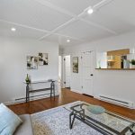 The kitchen stays defined without feeling cut off—the pass-through keeps conversation and sightlines moving across the main living space.