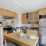 Sink, range and refrigerator are all within a step or two, with the worktable adding prep space in the middle.