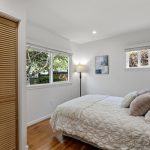 The prior occupant used this front bedroom as a home office—two exposures for daylight, and light rail nearby for the days the office isn’t at home.