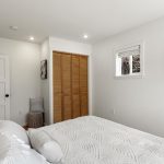 This angle shows the room’s proportions best: the bed fits comfortably, with clear circulation, usable wall space and morning light from the east-facing window.