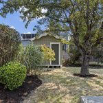 Even the back corner feels considered—the detached shed sits beneath mature canopy, with a front window for daylight and room for secure, dry bike storage, yard gear or potential studio/workspace use.