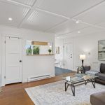 A full seating group fits without pinching the path through the house—one of those small-plan wins you can actually see.