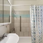 A south-facing window brings daylight to the full bath.