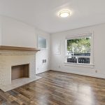 Unit B – Main Floor: high ceilings and three windows give the living room a noticeably more open feel.