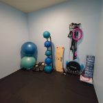 A separate fitness alcove adds space for stretching and floor work, with exercise balls, resistance gear, and mats.
