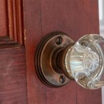 Vintage glass doorknob and paneled wood door — one of the home’s distinctive 1940s details.