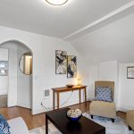 A simple arched opening adds a touch of 1906 character between the living room and hall.